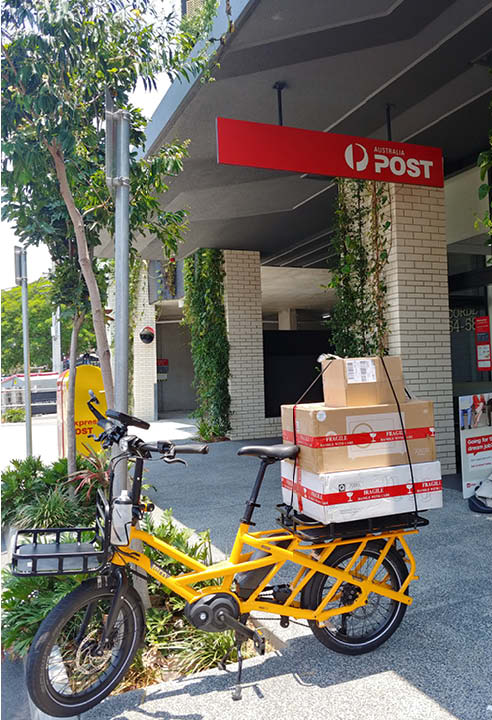 Tern GSD cargo electric bike collecting post from the post office
